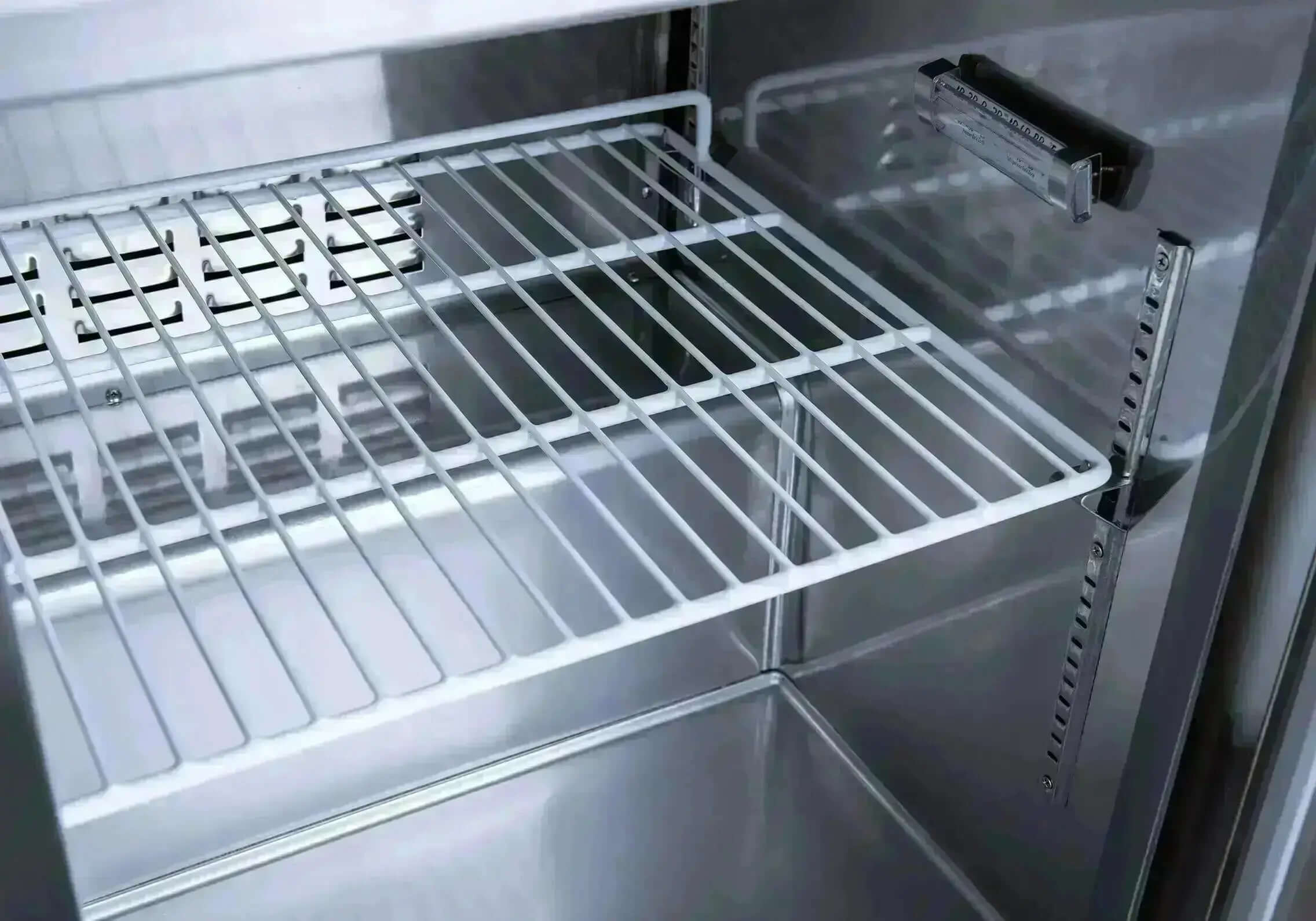 Interior view of the SCLM1 Refrigerated Mega Top Prep Table showing the wire shelving.