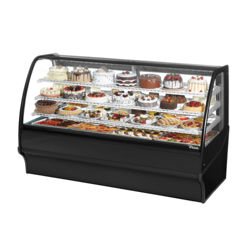 True Refrigeration curved glass bakery merchandiser displaying a variety of desserts and pastries in a black cabinet.